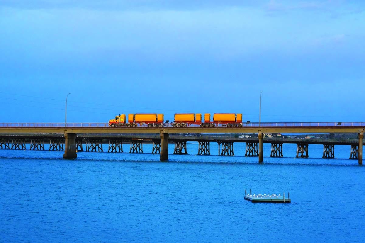 Australian road train crossing a bridge