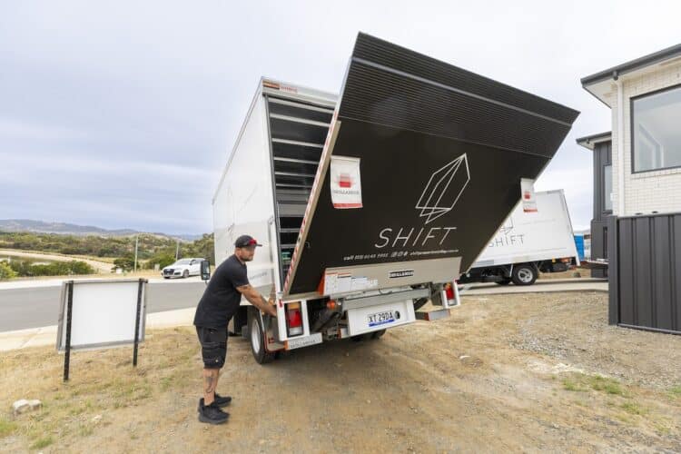 Isuzu NPR 75-190 with company-branded tailgate.
