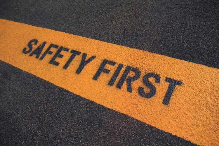 Safety First sign on caution strip.